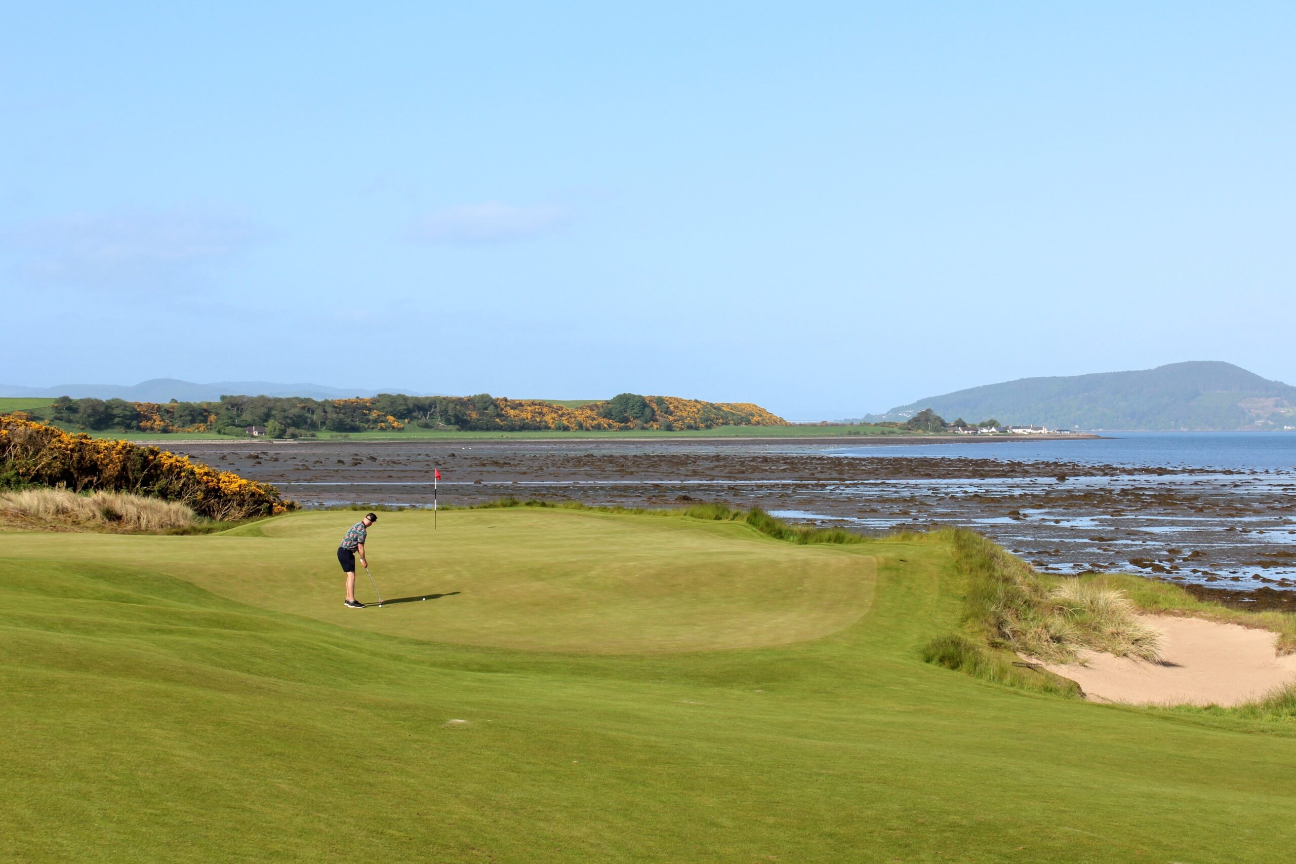 A,Man,Putting,On,A,Golf,Green,On,A,Links